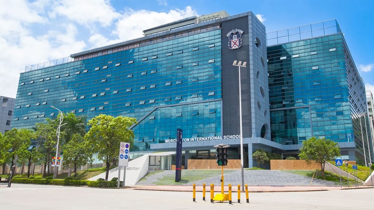 Merchiston International School Shenzhen blue glass building with school crest displayed