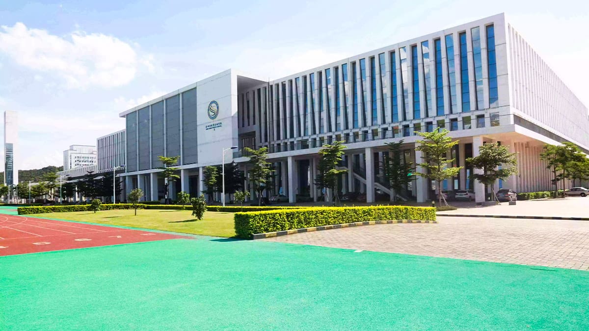 Shenzhen Sports School contemporary campus with green athletic surfaces and trees