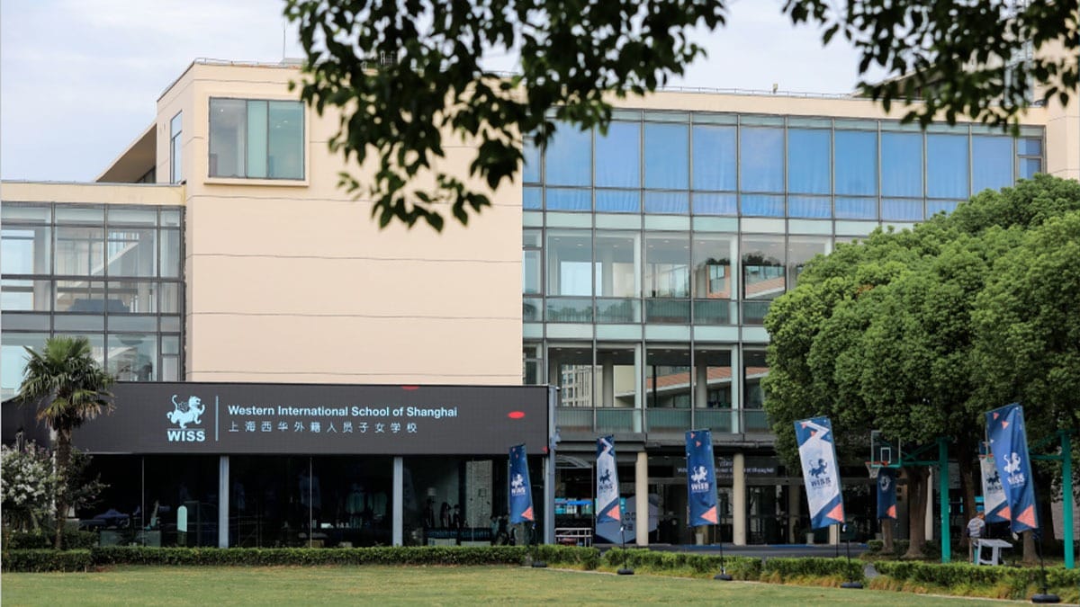 Western International School of Shanghai campus with glass facade and green grounds