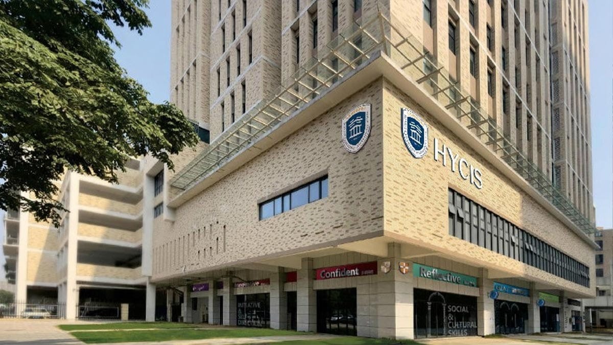 Hongyi Cambridge International School (HYCIS) modern beige building exterior with signage