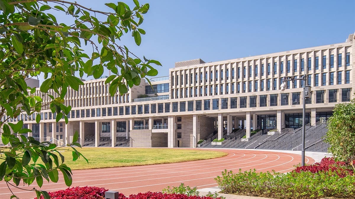 LEH International School Foshan campus building with running track and green landscaping