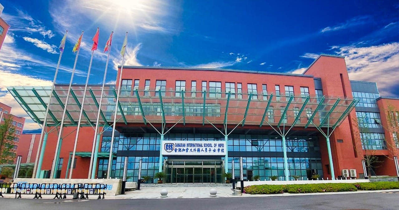 Canadian International School of Hefei modern campus building with flags