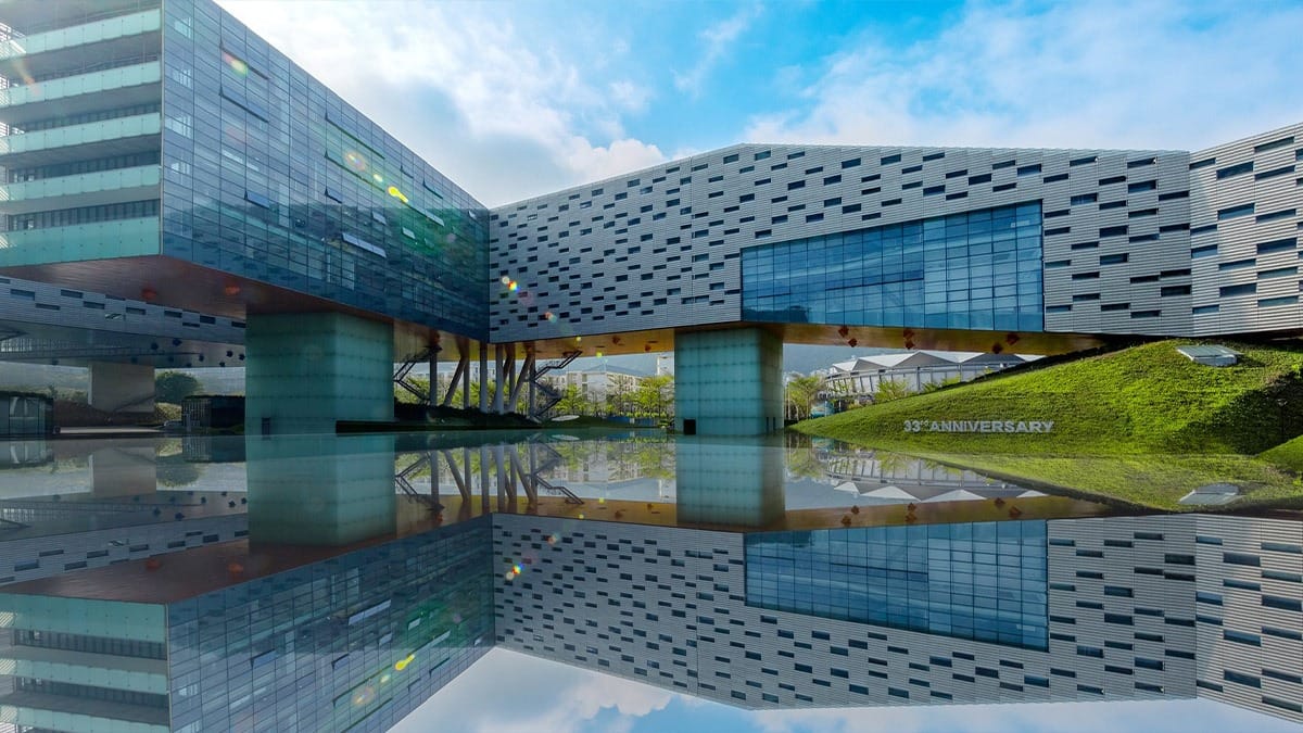 Shenzhen Meisha Bilingual School modern glass campus with reflective pool